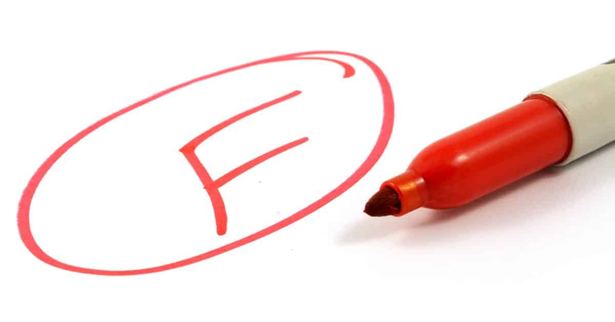 F written on a page in red with a marker sitting nearby