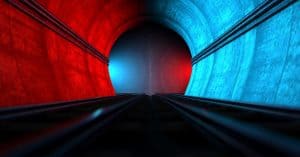 Diverging subway tunnel with red and blue lights on either side