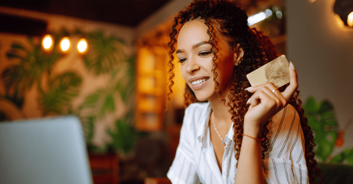 e-commerce fraud - woman using a credit card to shop online