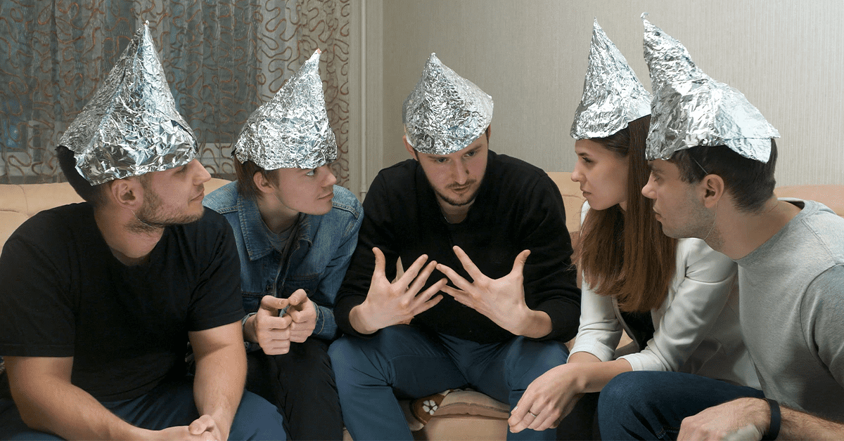 Conspiracy theorists wearing tinfoil hats discussing digital identity
